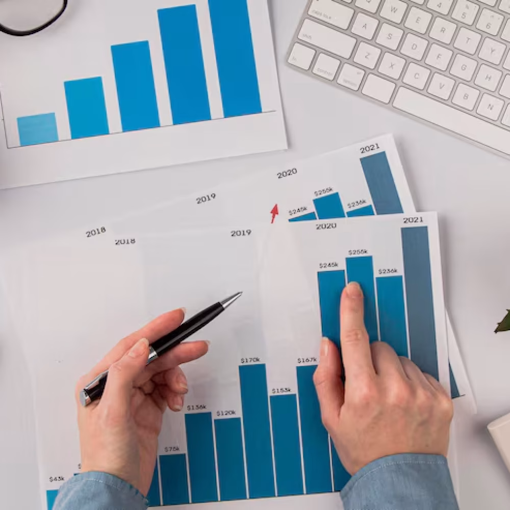 top-view-office-desk-with-growth-chart-hands_23-2148780615
